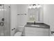 Modern bathroom featuring a sleek vanity, a large mirror, and a glass-enclosed shower at 7062 Nine Penny Dr, Brownsburg, IN 46112