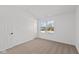 Bedroom featuring neutral carpet, a door, and a window at 7062 Nine Penny Dr, Brownsburg, IN 46112
