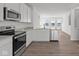 An open kitchen with sleek appliances, white cabinetry, and modern countertops at 7062 Nine Penny Dr, Brownsburg, IN 46112