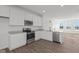 A modern kitchen featuring stainless steel appliances, white cabinetry, and a large center island at 7062 Nine Penny Dr, Brownsburg, IN 46112