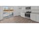 A modern kitchen featuring stainless steel appliances, white cabinets, and a sliding glass door at 7062 Nine Penny Dr, Brownsburg, IN 46112