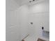 Small laundry room with white walls and storage shelves at 7062 Nine Penny Dr, Brownsburg, IN 46112