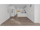 An open-concept living space with wood-look floors and bright natural light from the windows at 7062 Nine Penny Dr, Brownsburg, IN 46112