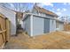 An exterior of the home with gray siding, backyard and a wooden fence at 714 S Keystone Ave, Indianapolis, IN 46203