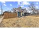 Cozy two-story home with a bright yellow front door and a wooden fence at 714 S Keystone Ave, Indianapolis, IN 46203