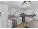 Bright kitchen featuring white cabinets, modern appliances, and stone backsplash at 714 S Keystone Ave, Indianapolis, IN 46203
