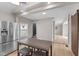 Open-concept kitchen features stainless steel refrigerator and wood dining table with stools at 714 S Keystone Ave, Indianapolis, IN 46203