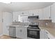 Well-lit kitchen with stainless steel appliances, granite countertops and hexagon backsplash at 714 S Keystone Ave, Indianapolis, IN 46203
