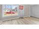 Clean living room featuring a large window and light-colored hardwood floors at 714 S Keystone Ave, Indianapolis, IN 46203