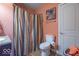 Bathroom featuring a shower with a striped curtain and a toilet with an accent painting at 7823 Beechwood Farms Dr, Avon, IN 46123