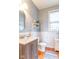 Bathroom with a wood vanity, decorative wall shelves, and a view of the outdoors at 7823 Beechwood Farms Dr, Avon, IN 46123