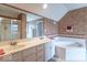 Elegant bathroom with double vanity, soaking tub, and separate shower, creating a spa-like retreat at 7823 Beechwood Farms Dr, Avon, IN 46123
