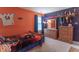 Sports themed bedroom with an orange and navy blue color scheme and decor at 7823 Beechwood Farms Dr, Avon, IN 46123