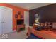 Sports-themed bedroom with orange and navy blue color scheme, featuring a TV and double door closet at 7823 Beechwood Farms Dr, Avon, IN 46123