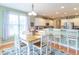 Inviting dining area with a wooden table, white chairs, and a view into the kitchen at 7823 Beechwood Farms Dr, Avon, IN 46123