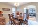 Dining room with a wooden table and chairs, chandelier, and view of the living room at 7823 Beechwood Farms Dr, Avon, IN 46123