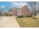 Beautiful brick home featuring an attached two-car garage and inviting driveway with a basketball hoop at 7823 Beechwood Farms Dr, Avon, IN 46123