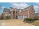 Charming brick home with attached two-car garage and meticulously maintained landscaping on a sunny day at 7823 Beechwood Farms Dr, Avon, IN 46123