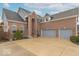 Spacious two-car attached garage, complemented by a well-manicured exterior and traditional brick facade at 7823 Beechwood Farms Dr, Avon, IN 46123