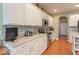 Well-lit kitchen with white cabinets, stainless steel appliances, and modern countertops at 7823 Beechwood Farms Dr, Avon, IN 46123