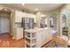 Modern kitchen with stainless steel appliances, center island, and seamless flow to other living spaces at 7823 Beechwood Farms Dr, Avon, IN 46123