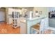 Open-concept kitchen with modern appliances, a breakfast bar, and hardwood floors at 7823 Beechwood Farms Dr, Avon, IN 46123