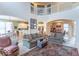 Bright living room with soaring ceilings, archways, comfortable furnishings, and seamless flow to dining and kitchen areas at 7823 Beechwood Farms Dr, Avon, IN 46123