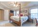 Charming main bedroom featuring a four-poster bed, tray ceiling, and ample natural light from multiple windows at 7823 Beechwood Farms Dr, Avon, IN 46123