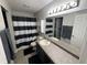Bathroom features a shower with a black and white curtain, vanity, and plenty of counter space at 785 Country Gate Dr, New Whiteland, IN 46184