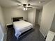 This bedroom features neutral walls and carpet, a ceiling fan, and closet for storage at 785 Country Gate Dr, New Whiteland, IN 46184