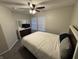 Cozy bedroom featuring neutral walls, ceiling fan, and a dresser with a mirror and TV at 785 Country Gate Dr, New Whiteland, IN 46184
