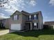 Attractive 2-story home with gray siding, 2-car garage, and a well-maintained front yard on a sunny day at 785 Country Gate Dr, New Whiteland, IN 46184