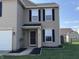 Inviting front entrance featuring a dark front door, black mulch, and well-maintained landscaping at 785 Country Gate Dr, New Whiteland, IN 46184
