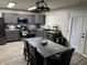 Spacious eat-in kitchen showcases gray cabinets, a modern sink, stainless steel appliances, and wood-look floors at 785 Country Gate Dr, New Whiteland, IN 46184