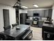 Eat-in kitchen featuring gray cabinets, modern appliances, a table with seating, and wood-look flooring at 785 Country Gate Dr, New Whiteland, IN 46184