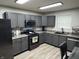 Modern kitchen boasts gray cabinetry, stainless steel appliances, and stylish wood-look flooring at 785 Country Gate Dr, New Whiteland, IN 46184