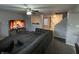Spacious living room features a large sectional sofa, ceiling fan, and a cozy fireplace display at 785 Country Gate Dr, New Whiteland, IN 46184