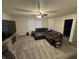 Spacious living room with a large sectional sofa, TV, and neutral gray walls at 785 Country Gate Dr, New Whiteland, IN 46184