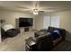 Comfortable living room with a sectional sofa, armchair, a TV, and neutral gray walls at 785 Country Gate Dr, New Whiteland, IN 46184