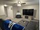 Large living room with an expansive gray sectional, TV, and neutral gray walls at 785 Country Gate Dr, New Whiteland, IN 46184