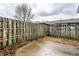 Fenced-in backyard featuring a concrete patio, privacy fencing, and foliage at 8004 Minlo Dr, Indianapolis, IN 46227
