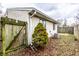 Fenced backyard with partial view of exterior, small tree and an air conditioning unit at 8004 Minlo Dr, Indianapolis, IN 46227