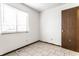 Bedroom featuring neutral walls and flooring, a window, and a door at 8004 Minlo Dr, Indianapolis, IN 46227