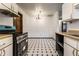 Eat-in kitchen and dining area featuring black and white tile flooring and ample natural light at 8004 Minlo Dr, Indianapolis, IN 46227