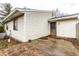 Beige home exterior featuring vinyl siding, a small patio, and a screen door at 8004 Minlo Dr, Indianapolis, IN 46227