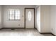 Bright foyer with ceramic tile flooring, a window, closet, and a classic-style front door at 8004 Minlo Dr, Indianapolis, IN 46227