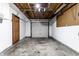 Attached garage with garage door, pegboard, and door to the interior of the home at 8004 Minlo Dr, Indianapolis, IN 46227
