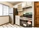 Updated kitchen with new stainless steel appliances and a black and white checkered tile floor at 8004 Minlo Dr, Indianapolis, IN 46227