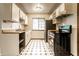 Galley kitchen features white cabinets, black and white tile floor, and stainless steel appliances at 8004 Minlo Dr, Indianapolis, IN 46227