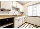 Kitchen features bright white cabinets, laminate counters and stainless sink at 8004 Minlo Dr, Indianapolis, IN 46227